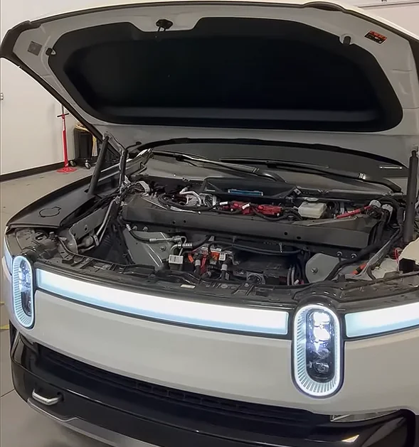 Rivian with its hood open and front service components exposed